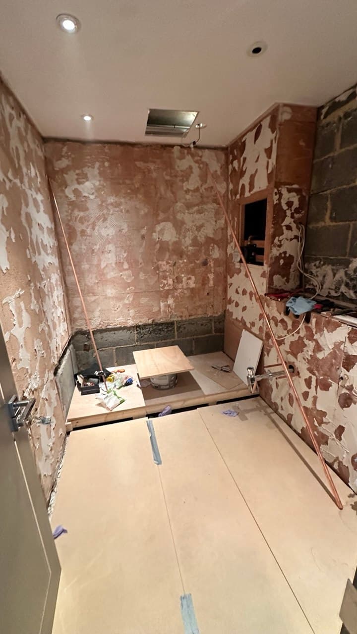 Master bathroom stripped back to bare walls and first-fix pipework