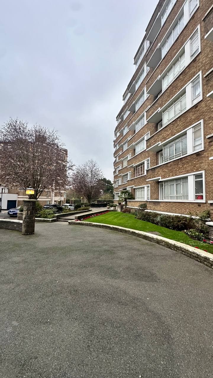 Landscaped grounds at Oslo Court with lawn and blossom trees