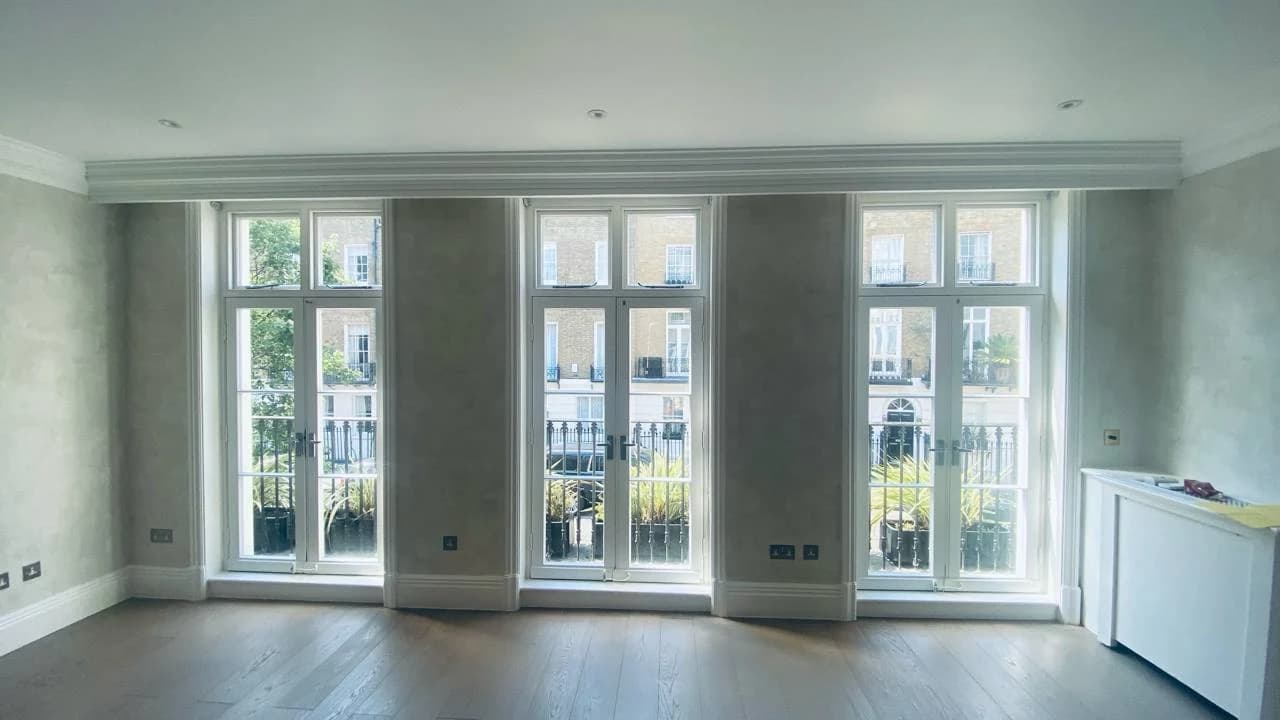 Completed reception with timber flooring, decorative wall finish and three sets of glazed doors